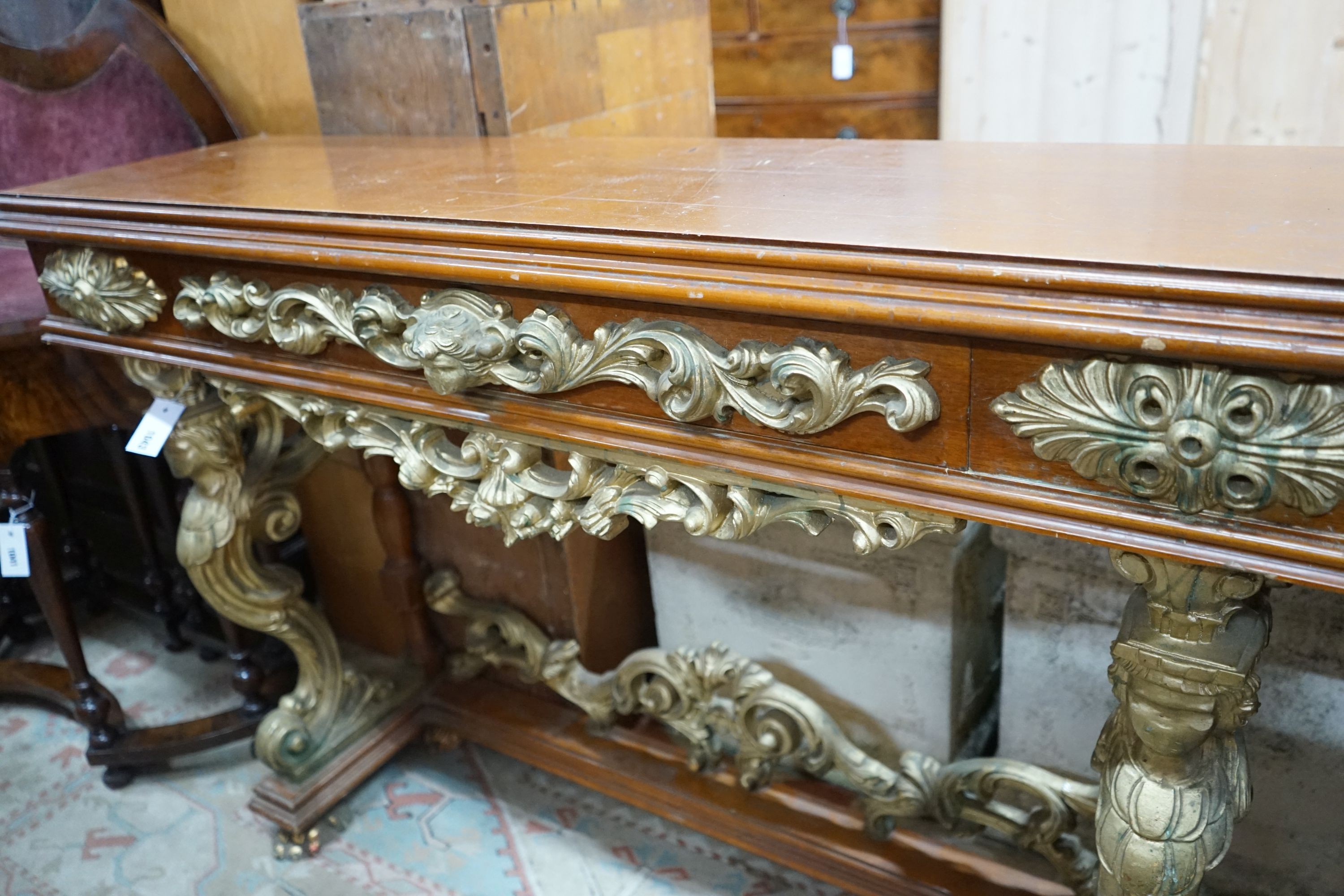 An 18th century style parcel gilt mahogany console table, width 136cm, depth 36cm, height 91cm